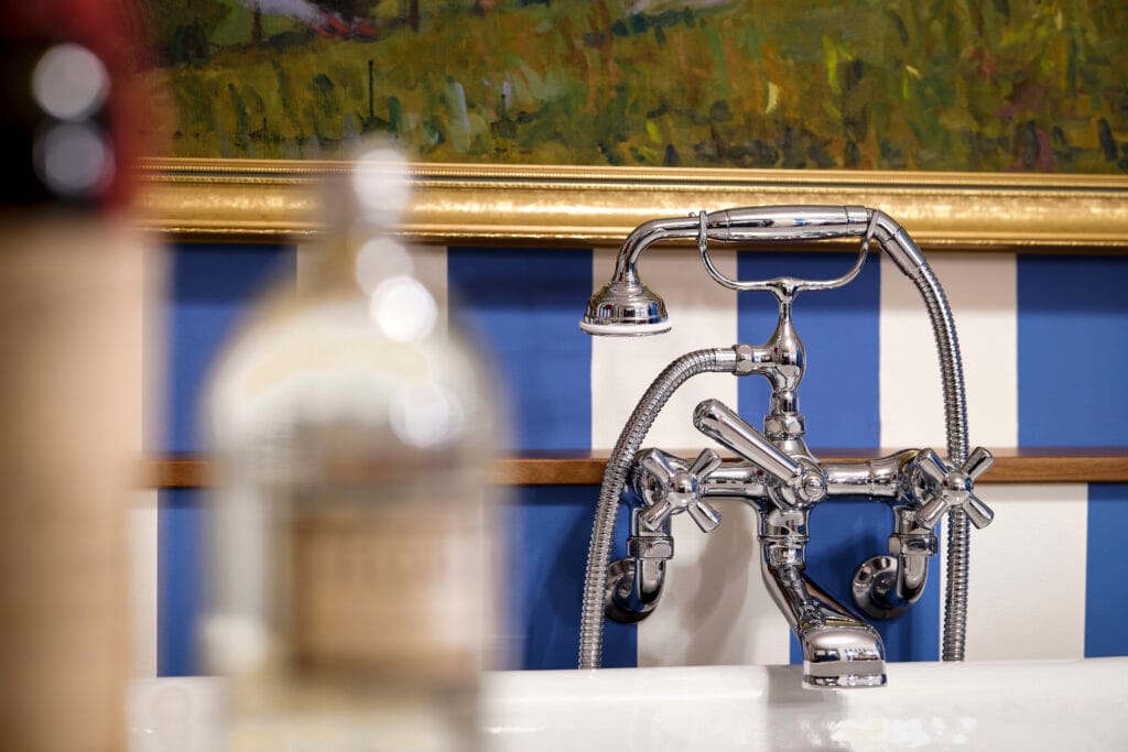 Hochwertiger Design-Badewannenmischer in Chrom mit blau weisser Tapete
